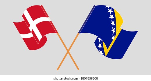 Crossed and waving flags of Denmark and Bosnia and Herzegovina