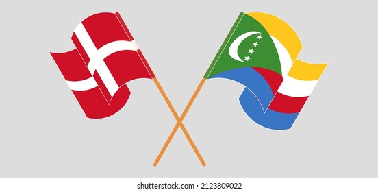 Crossed and waving flags of Denmark and Comoros. Vector illustration
