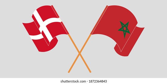 Crossed and waving flags of Denmark and Morocco