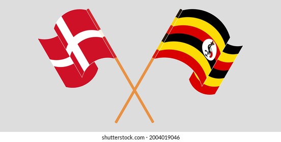 Crossed and waving flags of Denmark and Uganda