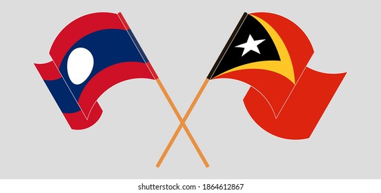 Banderas cruzadas y ondeando banderas de Timor Oriental y Laos