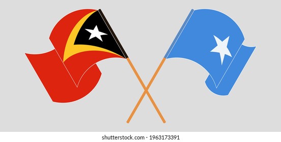 Crossed and waving flags of East Timor and Somalia