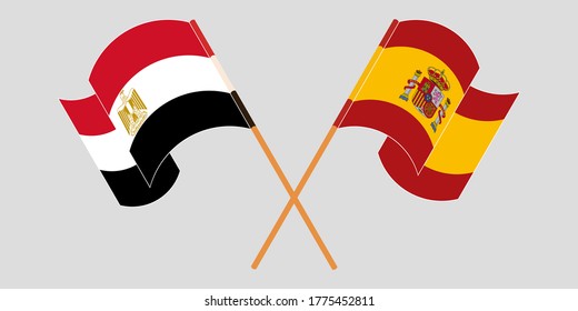 Crossed and waving flags of Egypt and Spain