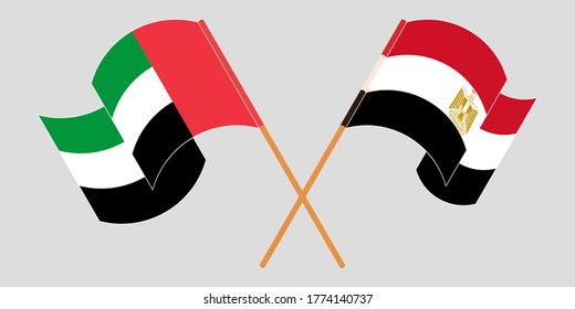 Banderas cruzadas y ondeando banderas de Egipto y los Emiratos Árabes Unidos