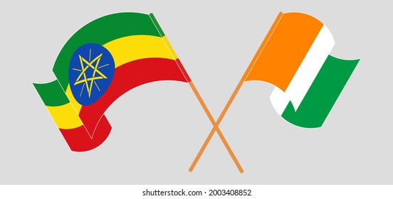 Crossed and waving flags of Ethiopia and Republic of Ivory Coast