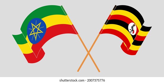 Crossed and waving flags of Ethiopia and Uganda