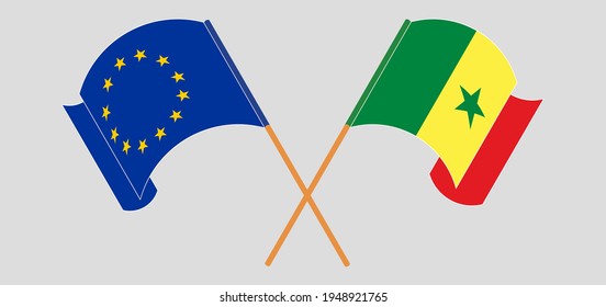 Banderas cruzadas y ondeando banderas de la Unión Europea y Senegal