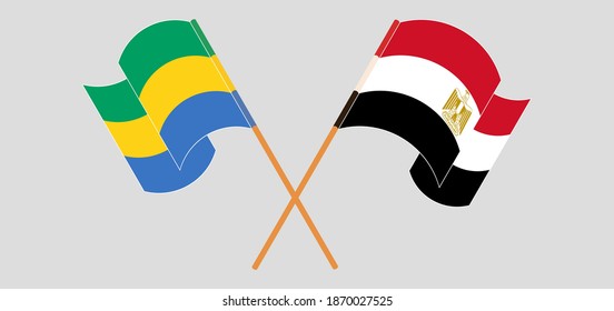 Crossed and waving flags of Gabon and Egypt
