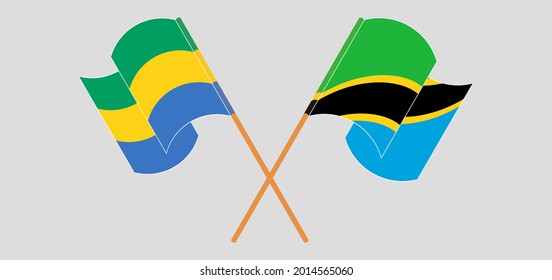 Crossed and waving flags of Gabon and Tanzania