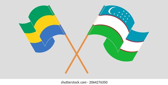 Crossed and waving flags of Gabon and Uzbekistan