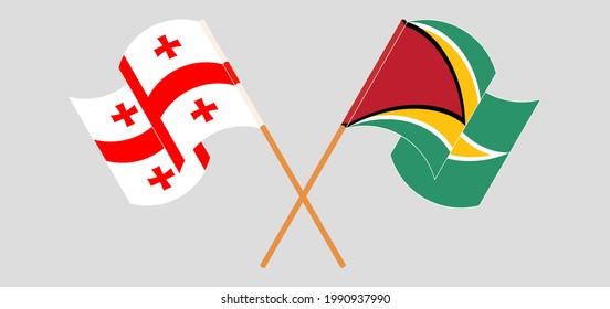 Crossed and waving flags of Georgia and Guyana