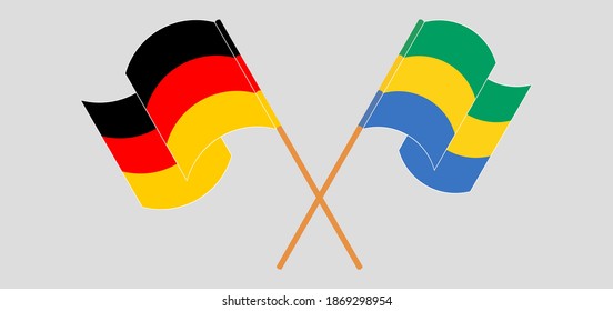 Crossed and waving flags of Germany and Gabon