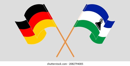 Crossed and waving flags of Germany and Kingdom of Lesotho. Vector illustration

