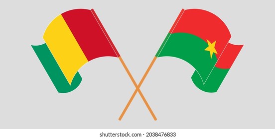 Crossed and waving flags of Guinea and Burkina Faso