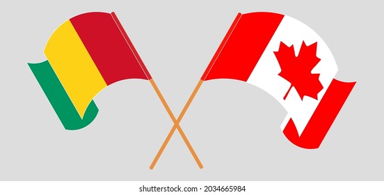 Crossed and waving flags of Guinea and Canada
