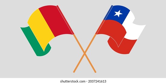 Crossed and waving flags of Guinea and Chile