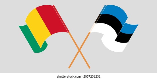 Crossed and waving flags of Guinea and Estonia