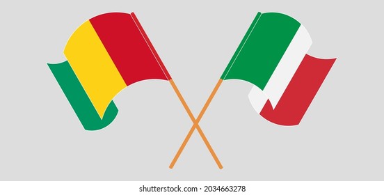 Crossed and waving flags of Guinea and Italy