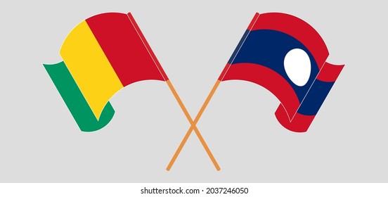 Crossed and waving flags of Guinea and Laos