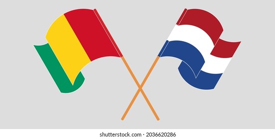 Crossed and waving flags of Guinea and the Netherlands