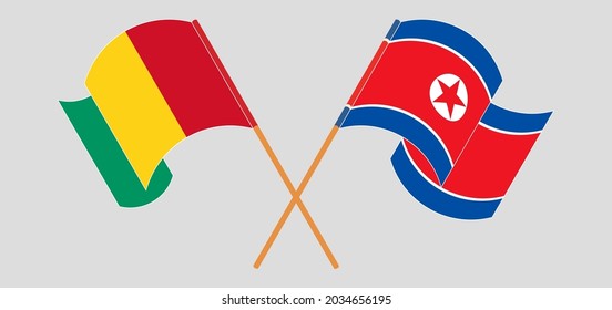 Crossed and waving flags of Guinea and North Korea