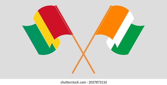 Banderas cruzadas y ondeando banderas de Guinea y la República de Costa de Marfil