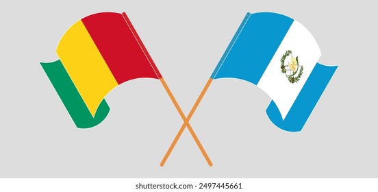 Crossed and waving flags of Guinea and Republic of Guatemala. Vector illustration
