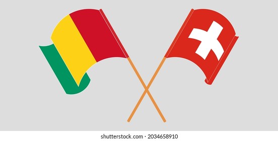 Crossed and waving flags of Guinea and Switzerland