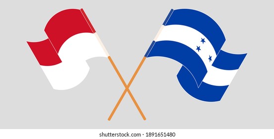 Crossed and waving flags of Honduras and Indonesia
