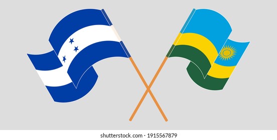 Crossed and waving flags of Honduras and Rwanda