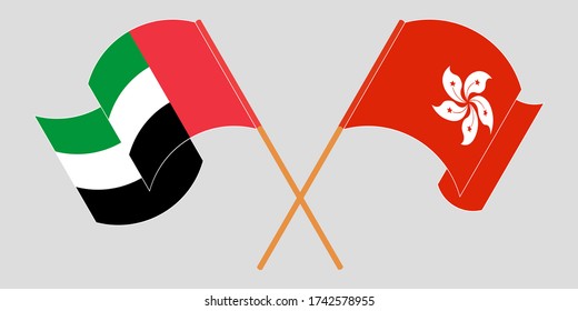 Crossed and waving flags of Hong Kong and the United Arab Emirates