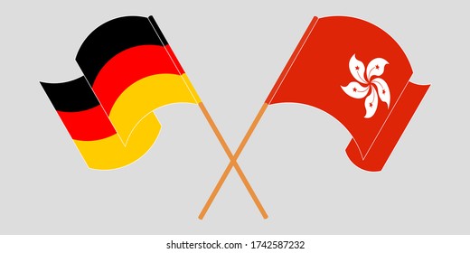 Überquerte und schwellende Flaggen Hongkongs und Deutschlands