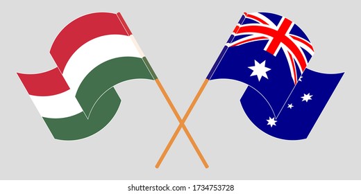 Crossed and waving flags of Hungary and Australia