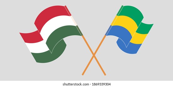 Crossed and waving flags of Hungary and Gabon