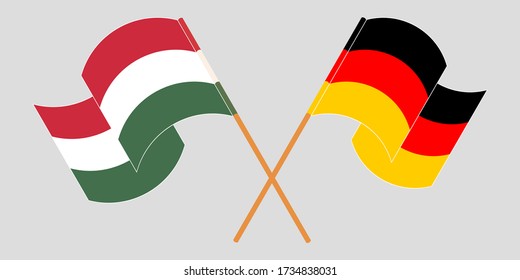 Crossed and waving flags of Hungary and Germany