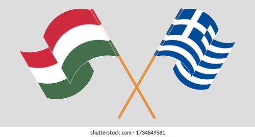 Crossed and waving flags of Hungary and Greece