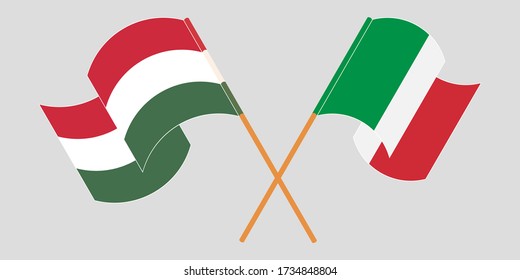 Crossed and waving flags of Hungary and Italy