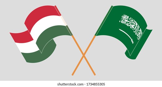 Crossed and waving flags of Hungary and Kingdom of Saudi Arabia