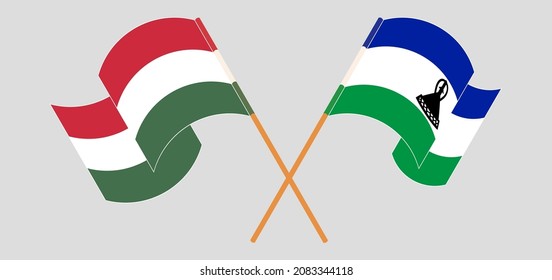 Crossed and waving flags of Hungary and Kingdom of Lesotho. Vector illustration
