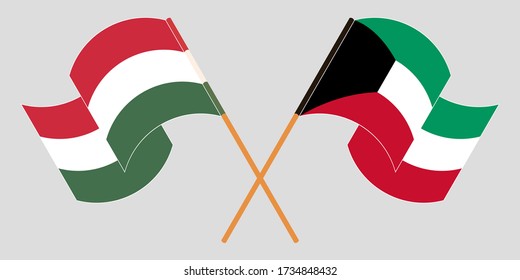 Crossed and waving flags of Hungary and Kuwait