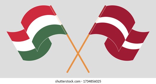 Crossed and waving flags of Hungary and Latvia