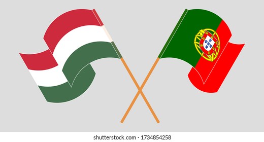 Crossed and waving flags of Hungary and Portugal