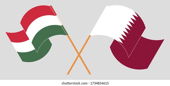 Crossed and waving flags of Hungary and Qatar