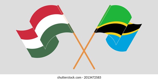 Crossed and waving flags of Hungary and Tanzania