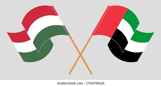 Crossed and waving flags of Hungary and the United Arab Emirates