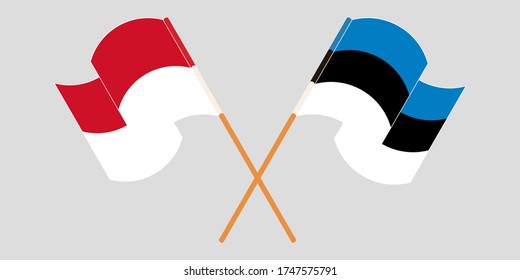 Crossed and waving flags of Indonesia and Estonia