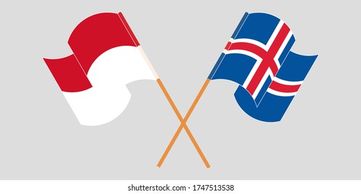 Crossed and waving flags of Indonesia and Iceland