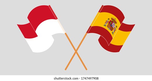 Crossed and waving flags of Indonesia and Spain