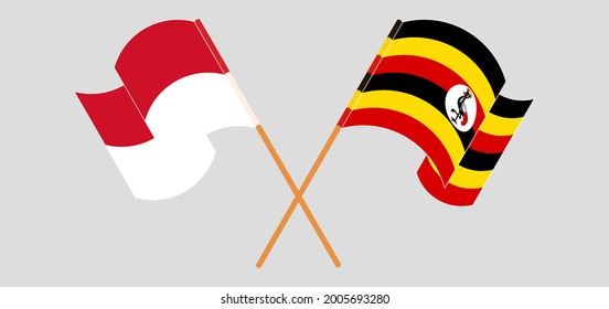 Banderas cruzadas y ondeando banderas de Indonesia y Uganda