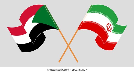 Crossed and waving flags of Iran and Sudan